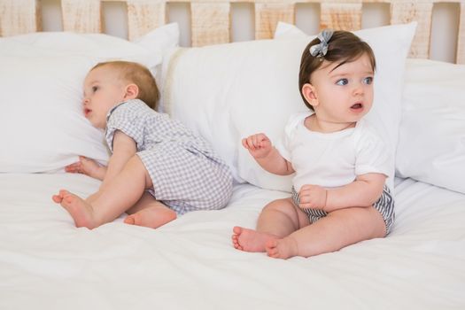 Very beautiful cute babies boy and girl at home in bedroom
