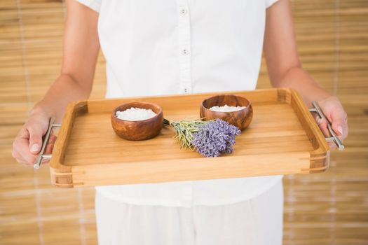 Therapist holding tray of beauty treatments at the spa