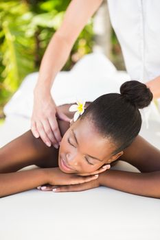 Close up of a beautiful young woman on massage table outdoors