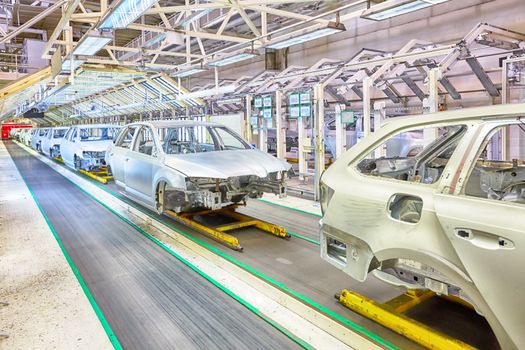 prepared chassis in a row at car plant