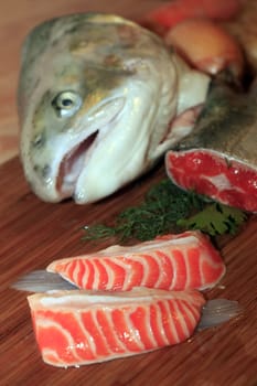 Fresh red salmon fish on wooden cooking desk