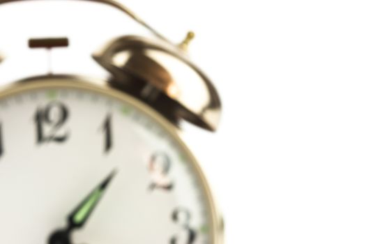 Close up of an alarm clock on a white background - blurred