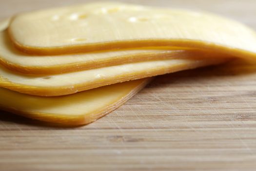 Thin plate of cheese on a wooden board