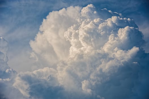 Large fluffy cloud relief details on blue sky