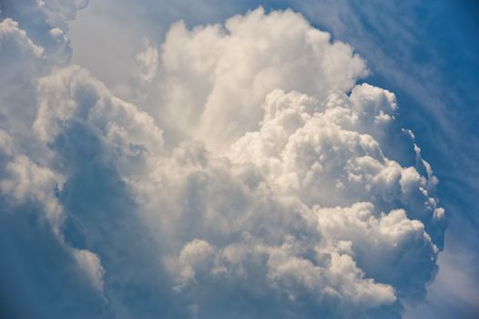 Large fluffy cloud relief details on blue sky