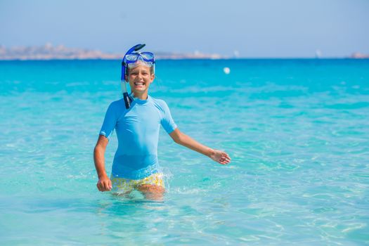 Happy cute girl wearing snorkeling mask ready to dive in the sea