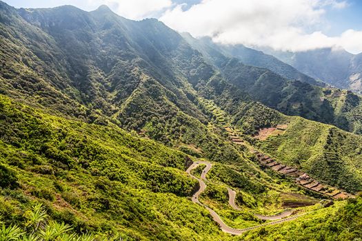 Nature landscape with green mountains or rocks valley with serpantine road and sky in Tenerife Canary island, Spain at summer or spring