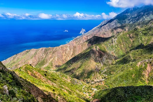 Coast or shore of Atlantic ocean with  mountain or rock and blue sky with clouds and skyline in Tenerife Canary island, Spain at spring or summer