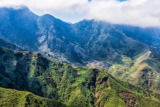 Clouds over mountain landscape with serpantine road in Tenerife Canary island, Spain