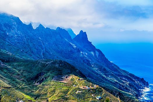 Coast or shore of Atlantic ocean with  rock and  sky with clouds and horizon in Tenerife Canary island, Spain at spring or summer