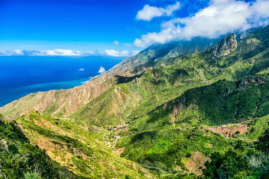 Green mountains or rocks with clouds  and  sky horizon near the Atlantic ocean landscape in Tenerife Canary island, Spain