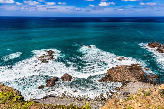 Stone coast or shore of ocean and sky with clouds and skyline or horizon landscape in Tenerife Canary island, Spain at spring or summer
