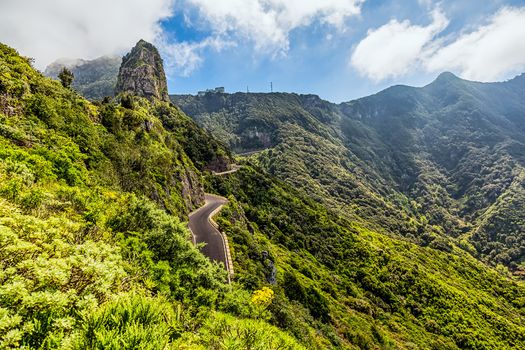 Landscape with green mountains or rocks valley with winding or serpantine road and sky in Tenerife Canary island, Spain at summer or spring