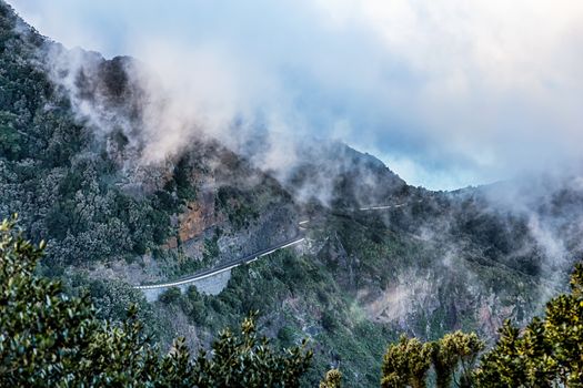 Clouds over mountain landscape with winding road in Tenerife Canary island, Spain