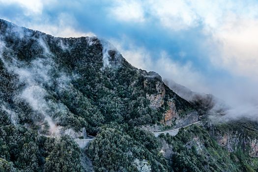Clouds over mountain with road in Tenerife Canary island, Spain