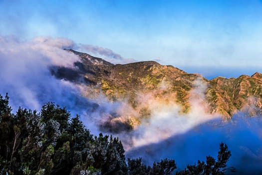 White and pink clouds over mountain landscape in Tenerife island, Spain