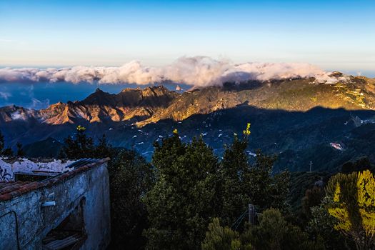 Mountain and clouds over peak landscape with sky horizon and old grunge building in Tenerife Canary island, Spain