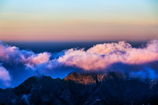 Pink clouds over mountain and sky horizon landscape in Tenerife island, Spain at sunset