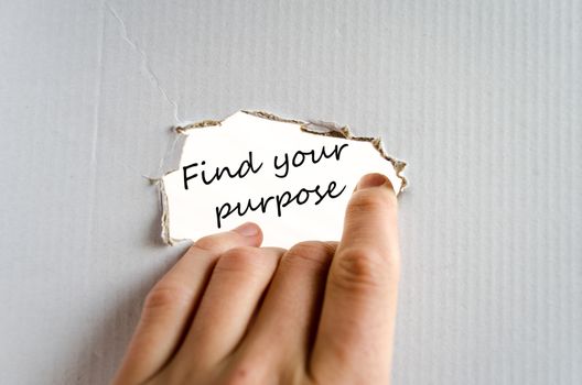 Hand and text on the cardboard background Find your purpose
