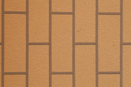 Brown brick wall. A square brick tile wall.