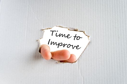 Hand and text on the cardboard background Time to improve