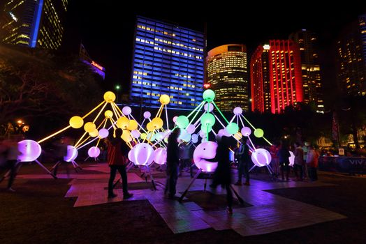 SYDNEY, AUSTRALIA, MAY 25, 2015:  Tourists and local public enjoy the Affinity installation at Vivid Sydney, which  depict the dazzling complexity and connectivity of the human brain and neurons.  When stimulated by touch, the orbs set-up a striking display of sound and light.  People in motion.  Artists:  amigo & amigo (Simone Chua & Renzo B. Larriviere ) + S1T2 (Chris Panzetta & Naimul Khaled)