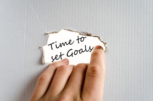 Hand and text on the cardboard background Time to set goals