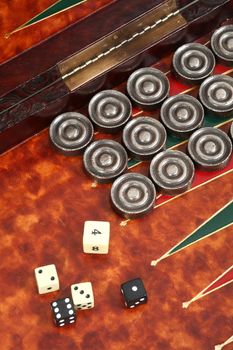 backgammon in the carved box inlaid with skin, counters and bones on a white background