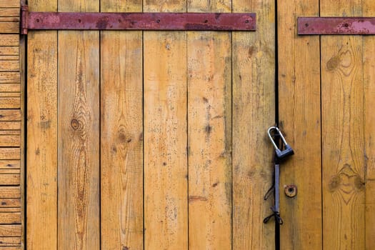 Wooden door of the boards with a padlock