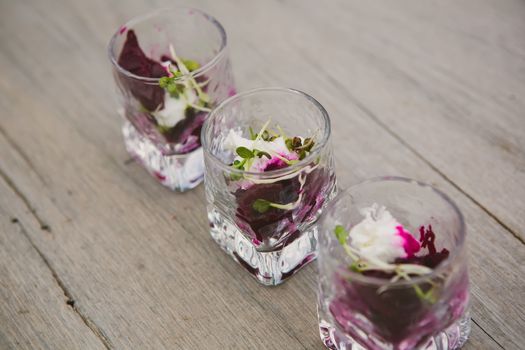 Vegetarian aperitif with beet, goat cheese and soy sprouts