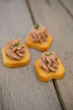 Delicious Pate Canapes on wooden background. Selective focus, shallow DOF