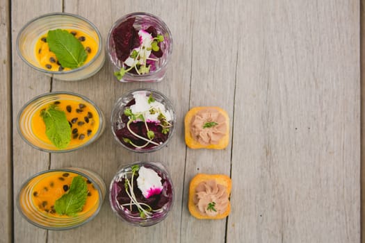Catering. Salad in a glass on a wooden table