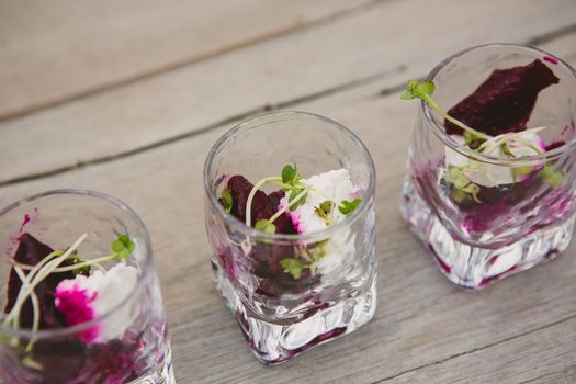 Vegetarian aperitif with beet, goat cheese and soy sprouts