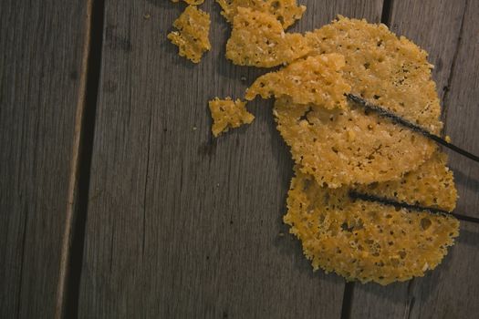 fried parmesan cheese on a wooden background.