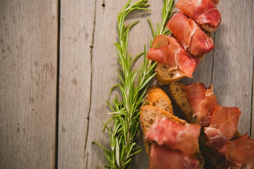 sliced prosciutto on a wooden board. Close up