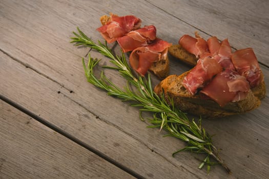 sliced prosciutto on a wooden board. Close up