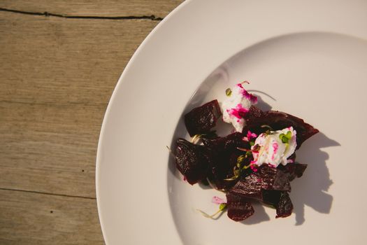 Vegetarian aperitif with beet, goat cheese and soy sprouts