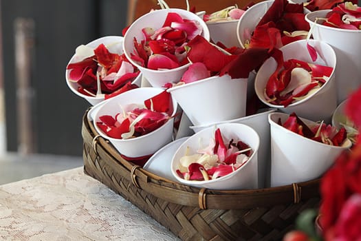 Rose petals in cup for scattering in wedding