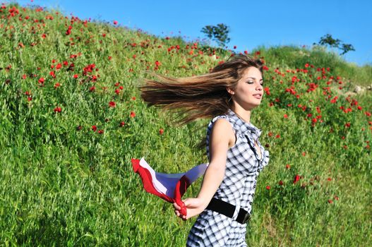 attractive tten girl running in poppy field