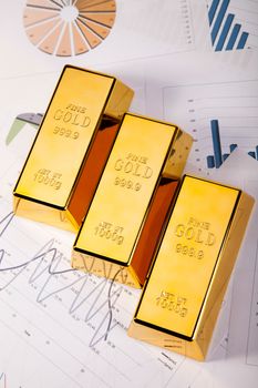Gold bars with a linear graph, ambient financial concept