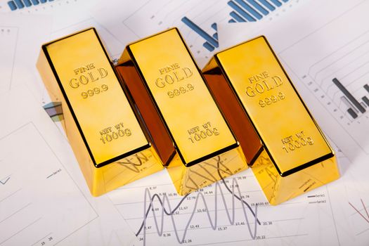Gold bars with a linear graph, ambient financial concept
