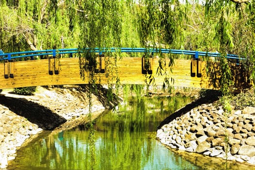 Wooden bridge over a canal in the city park
