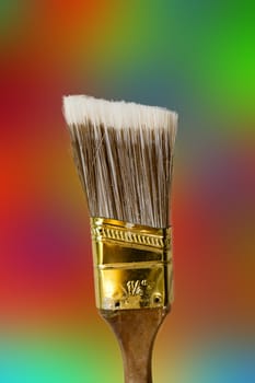 brush for painting and artwork photographed against a colored background