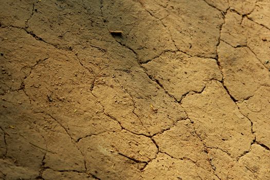 Shadow and light on a barren land-dry cracked brown earth