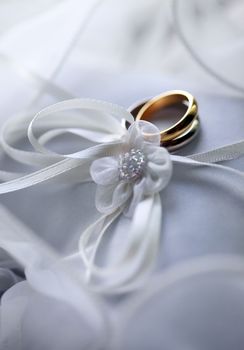 Wedding rings on a white satiny fabric