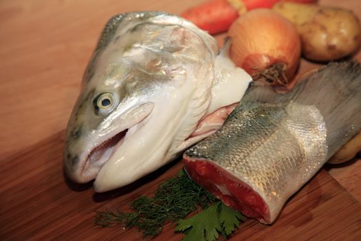 Fresh red salmon fish on wooden cooking desk