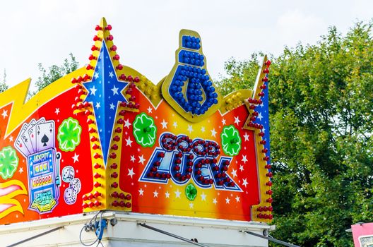 Essen Werden, Nrw, Germany - September 7, 2014: Known September fair, fair in Essen Werden in the parking lot at the church. A group of people, visitors in front of a children's carousel. enjoy the hot late summer day. The name funfair is the abbreviation of the word church weih fair.