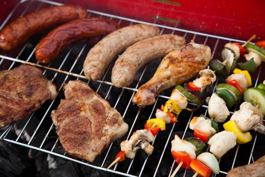 Grilling meat in flames, tasty dinner