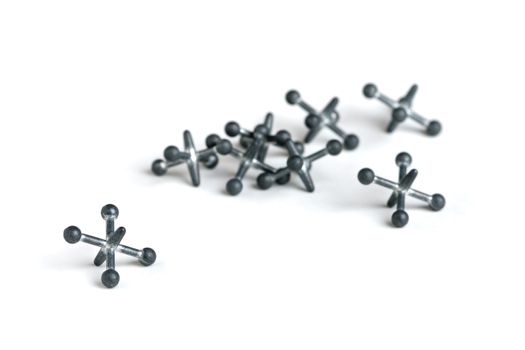 A set of metal jacks isolated against a white background.