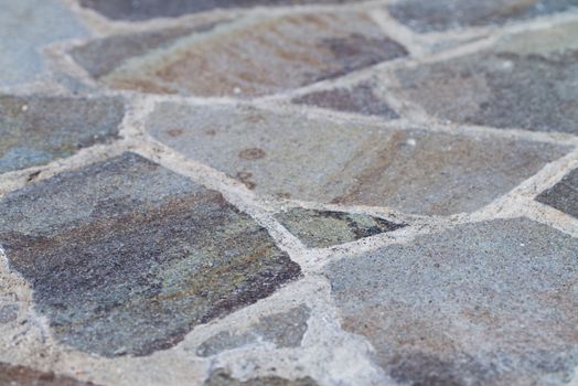 A Flagstone Patio shot at an angle fading into a blurred background.